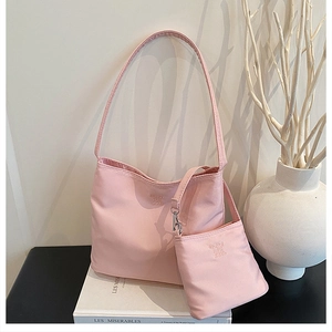 Pink nylon shoulder bag with matching mini pouch and embossed 'Enjoy your life' text