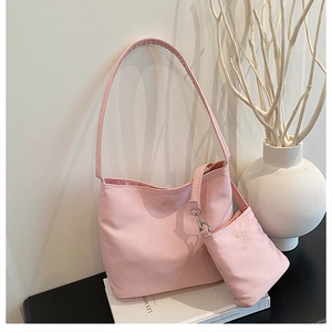 Detail view of pink nylon bucket bag with matching mini coin purse on a stylish display