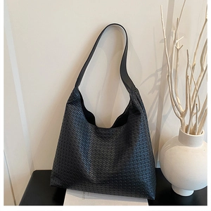 Close-up of the black woven leather texture and spacious design of this large tote bag