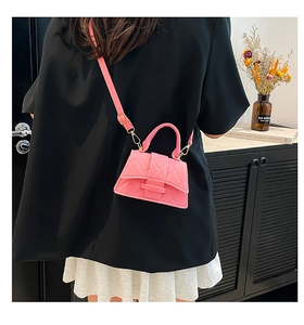 Pink quilted crossbody bag with gold hardware styled with a black blazer outfit