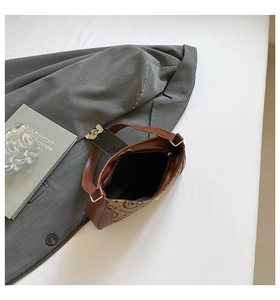 Detail view of vintage French baguette bag showing the zipper and leather stitching texture