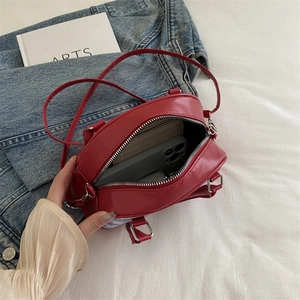 Red leather plaid top handle bag showing interior storage and blue striped detail
