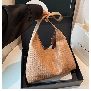 Detailed view of caramel woven tote bag featuring high-quality grid pattern and texture