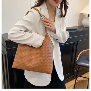 Detailed close-up of brown woven texture and classic square grid pattern on tote bag