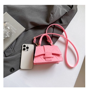 Detail of a mini pink quilted handbag in wool texture next to a smartphone