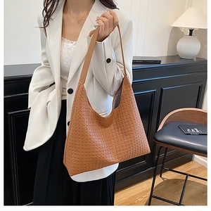 Detail of premium brown woven texture on large hobo shoulder bag for professional women