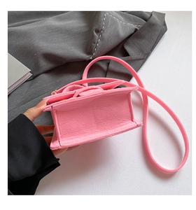 Close-up of pink felt crossbody bag showing bottom stitching and material texture