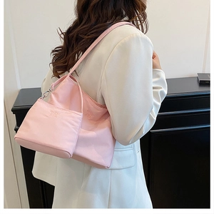 Close-up of pink nylon tote set with 'ENJOY THE LIFE' embroidery on the shoulder bag