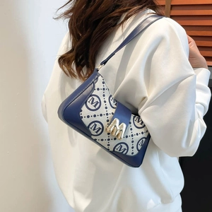 Vintage French monogram underarm bag with blue leather trim and golden M-shaped buckle
