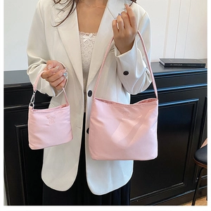 Pink nylon shoulder bag set with textured embroidery and silver metal zippers