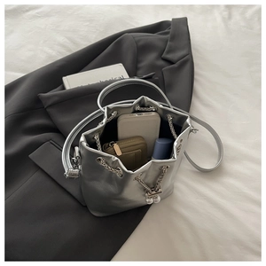 Silver bucket bag interior showing large capacity for phone, wallet and cosmetics