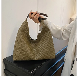Detail of olive green woven hobo bag showing high-capacity design and leather texture