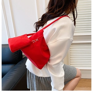 Detail of red nylon shoulder bucket bag with matching mini pouch and metal hook