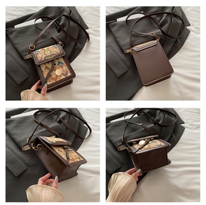 Detail view showing brown leather crossbody bag with colorful geometric patterns and gold charm
