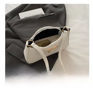 Interior view of white pebble leather baguette bag showing spacious storage capacity
