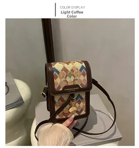 Detail of vintage woven crossbody bag in light coffee leather with golden metal charm