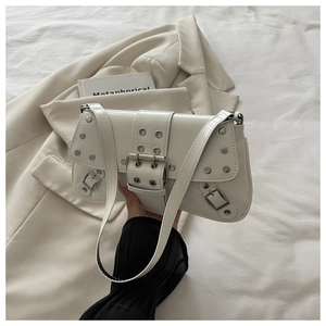 Detail of white punk style shoulder bag with silver rivets and metallic eyelets