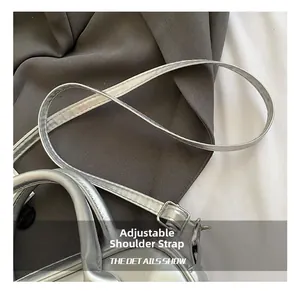 Close-up of the adjustable silver shoulder strap with metal buckle on the Boston bag