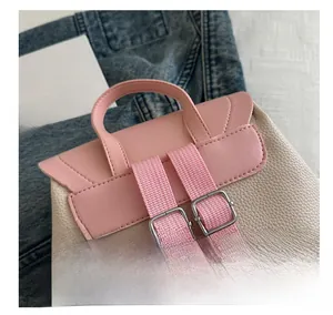 Detail of pink and beige mini backpack with litchi grain texture and adjustable straps