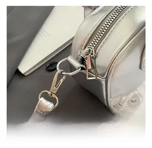 Detail of silver metallic mini bag featuring heart lace trim and high-quality hardware hook