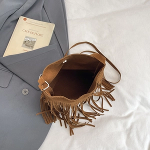 Chic brown suede bucket bag with long tassels and silver metal buckle hardware