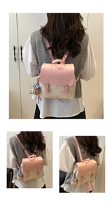 Detail of pink flap with embossed fashion text and butterfly print on stylish backpack