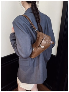 Brown vintage style shoulder bag with shiny faux leather and silver metal buckles