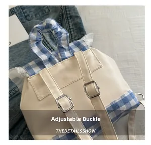 Detail of adjustable buckles on blue plaid lace backpack with ruffled edge trim