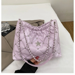 Close-up of quilted lavender tote bag with rhinestone star detail and silver chain strap
