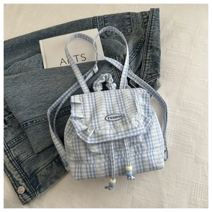 Detail of light blue checkered mini backpack with lace trim and beaded drawstring closure
