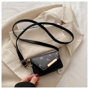 Close-up of mini cherry print crossbody bag showing gold metal detail and PU texture