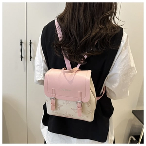 Detail of pink and beige patchwork backpack featuring butterfly prints and fashion embossing