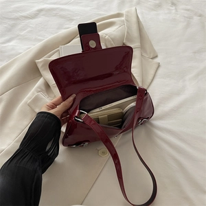 Punk style wine red patent leather shoulder bag with spacious interior for storage