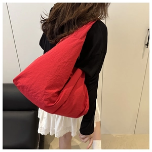 Detail of red large capacity nylon tote bag with pleated texture for casual daily use