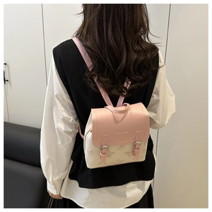 Detailed back view of pink and off-white mini backpack with butterfly pattern and straps