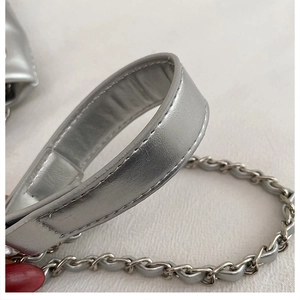 Detail of silver chain strap with interwoven faux leather for a modern tote bag