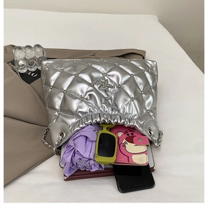 Spacious quilted silver chain bag interior showcasing capacity for phone and sunglasses
