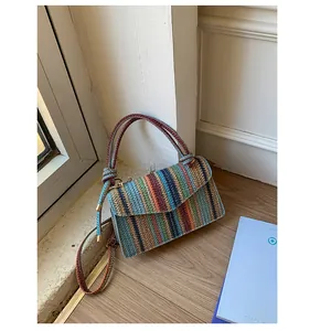 Detail of colorful striped woven texture and metal buckle on the chain crossbody bag