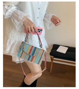 Detail of the colorful striped woven bag with bohemian hand-woven texture and handle