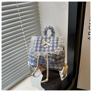 Detailed close-up of blue plaid lace backpack with bow and ruffle edge details
