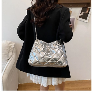 Silver metallic crossbody bag with quilted rhombic pattern and star detail