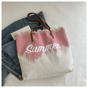 Detail of pink tie-dye canvas tote with Summer print, frayed edges and leather handles
