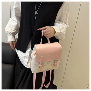 Detail view of pink and beige mini backpack with butterfly print and twin buckles