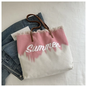 Detail of pink gradient canvas tote with Summer lettering and fringe edges