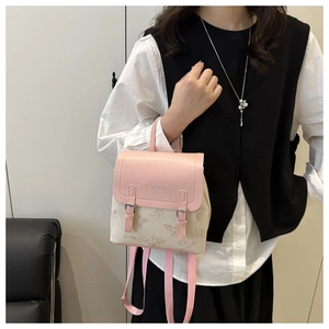 Detail of light pink and white mini backpack with butterfly pattern and silver logo