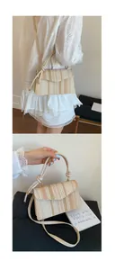 Detailed view of handmade woven straw crossbody bag with striped pattern and top handle