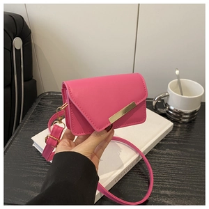 Detail of rose red mini flap crossbody bag with gold metal trim and adjustable strap