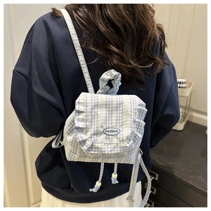 Detail of the blue gingham lace backpack with ruffle edges and embroidered fashion text