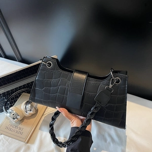 Retro black crocodile pattern baguette bag with stylish woven handle shown with accessories