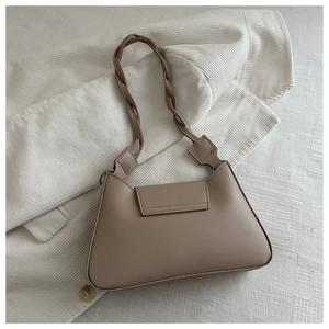 Detail of light brown shoulder bag featuring a unique braided knot strap design